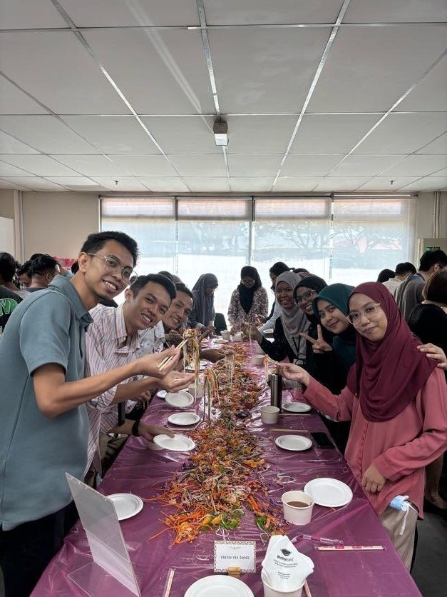 Staff tossing yee sang together at the Chinese New Year celebration